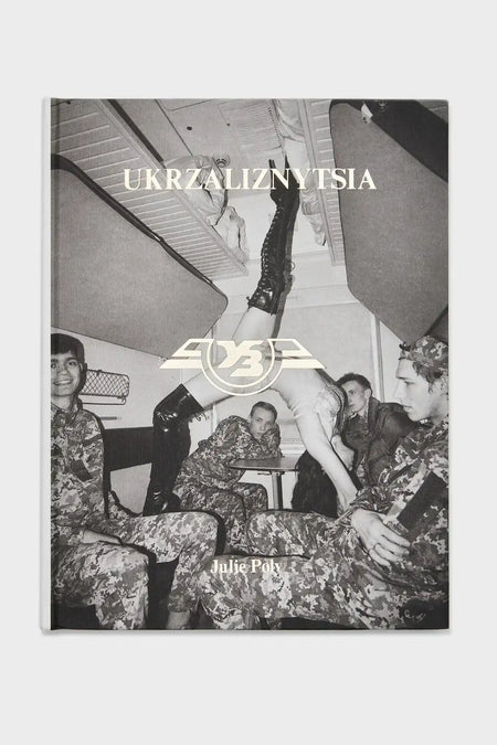 Black and white book cover with soldiers in camo uniforms, woman in boots, train compartment