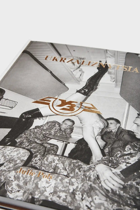 Book cover featuring black and white photo of soldiers in camouflage and a woman in boots, accented with gold text.