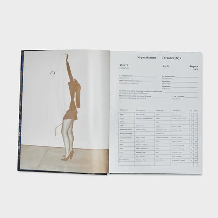 Open fashion coffee table book with artistic photo of woman and contents page in Ukrainian.