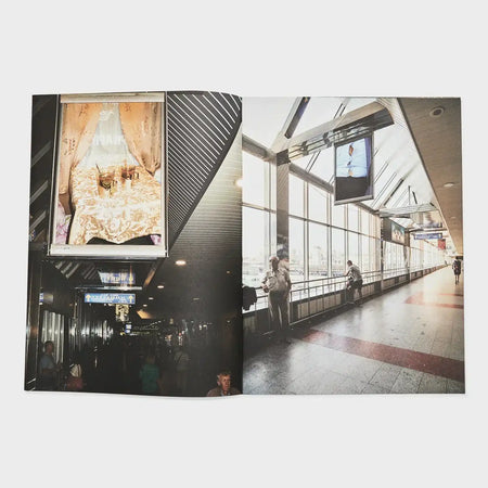 Open book with photos of an indoor passage, people, and window displays