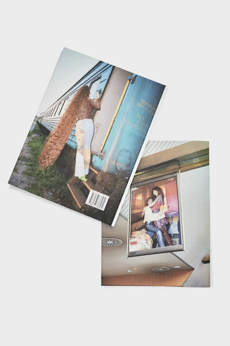 Two fashion magazines with retro train and stylish models on the covers, lifestyle photography