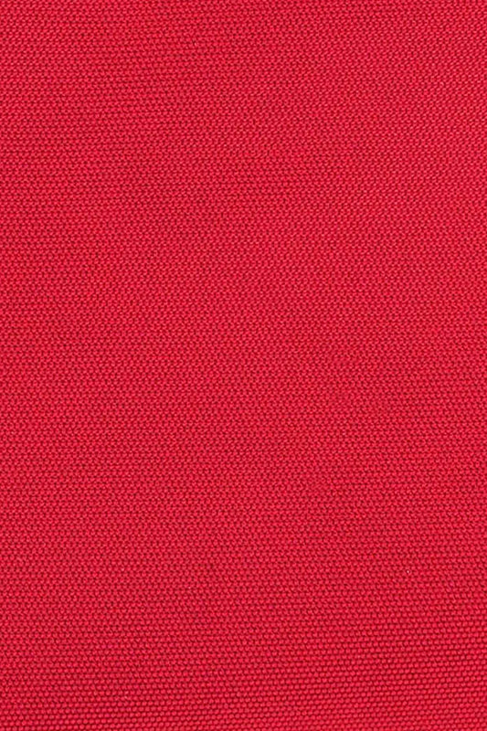 Close-up of textured red cotton fabric, ideal for clothing or fashion accessories