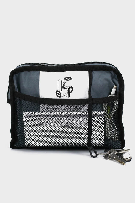 Black mesh travel pouch with zipper, visible keys and organized electronic accessories inside